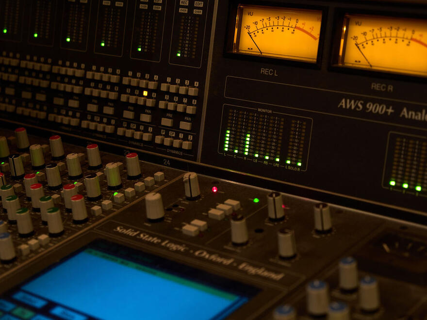 Illuminated mixing console and VU meters in the Nickel Studios control room. Illuminated mixing console and VU meters in the Nickel Studios control room.