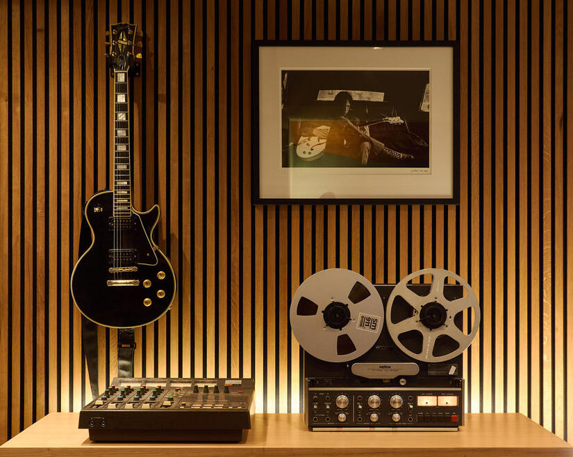 Reel-to-reel tape machine, black electric guitar and mixing equipment in Nickel Studios. Reel-to-reel tape machine, black electric guitar and mixing equipment in Nickel Studios.