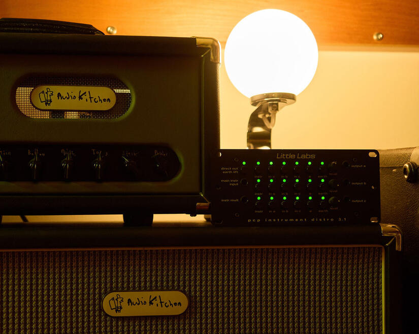 Audio Kitchen amplifier and routing equipment beside a globe lamp. Audio Kitchen amplifier and routing equipment beside a globe lamp.