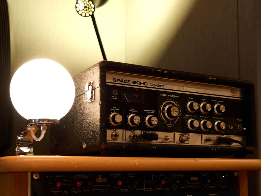 Roland Space Echo tape delay beside a globe lamp in the studio. Roland Space Echo tape delay beside a globe lamp in the studio.
